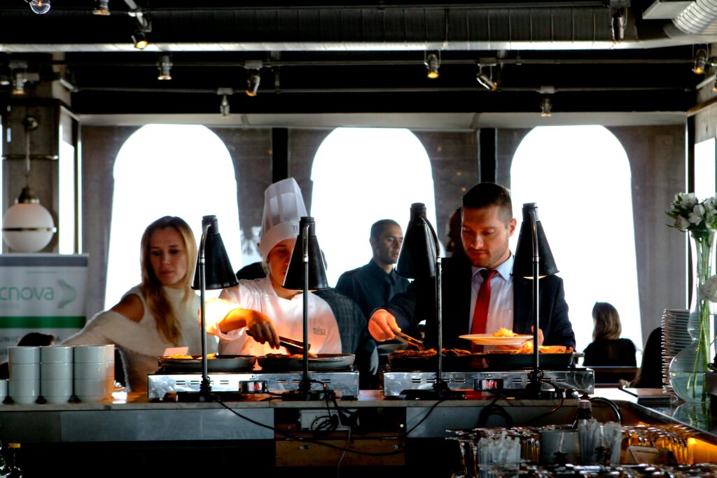 Business professionals enjoying a buffet meal in a contemporary indoor restaurant setting.